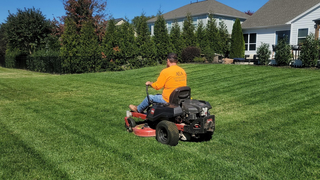 Homeowner enjoying a low-maintenance native garden that reduces mowing and upkeep costs