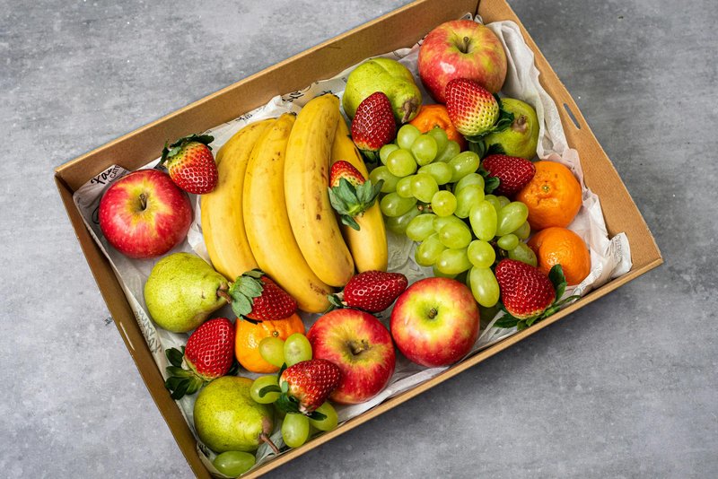 A delicious assortment of fresh fruits including apples, bananas, strawberries, and grapes.