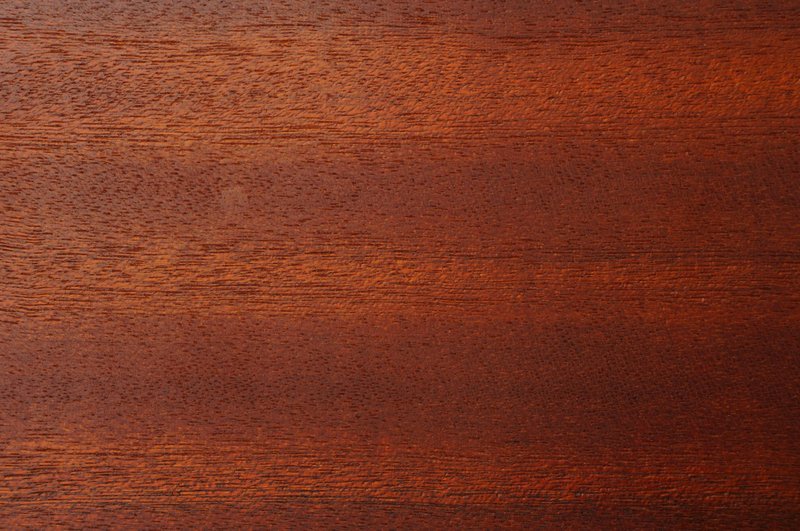 Close-up image of a rich brown wood texture, perfect for backgrounds and design.
