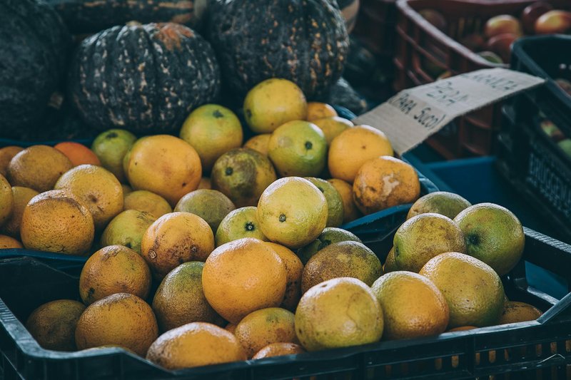 Basket of fresh citrus fruits on display at a local market stall.