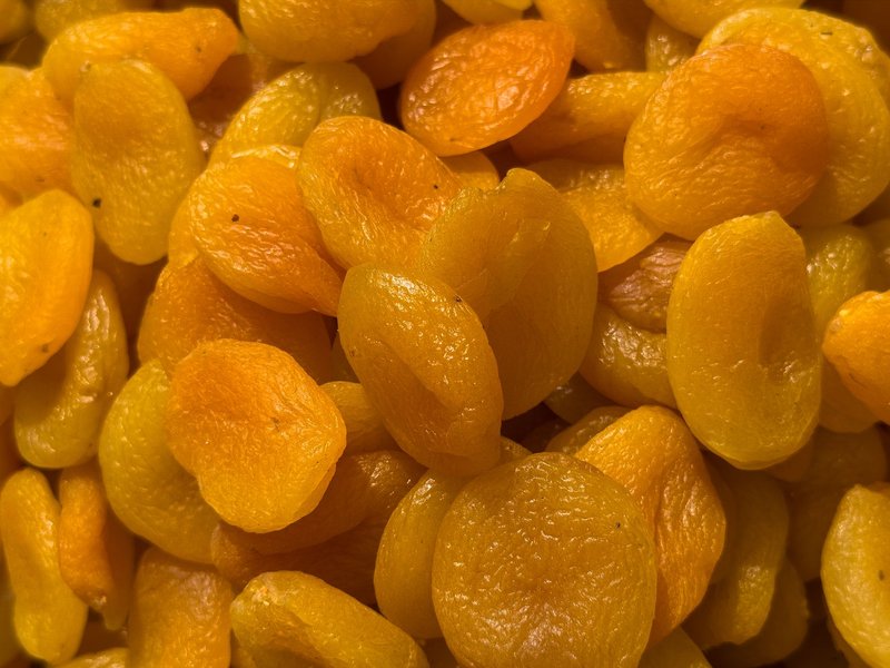 A detailed view of vibrant dried apricots showcasing their natural texture, perfect for healthy eating.