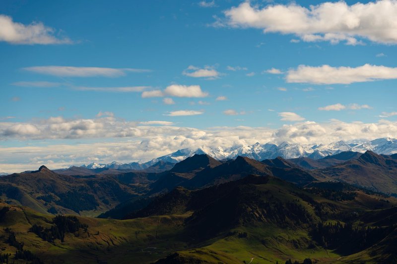 Majestic alpine mountains with snow peaks under a clear blue sky, perfect for travel inspiration.