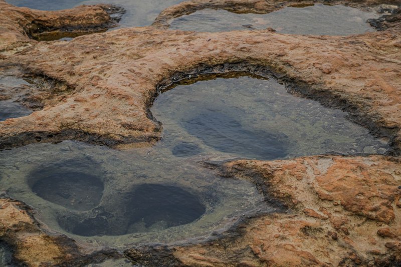 Explore unique rock formations with shallow water pools in New Taipei City, Taiwan.