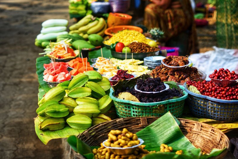 Colorful assortment of fresh fruits displayed for sale at a market stall.