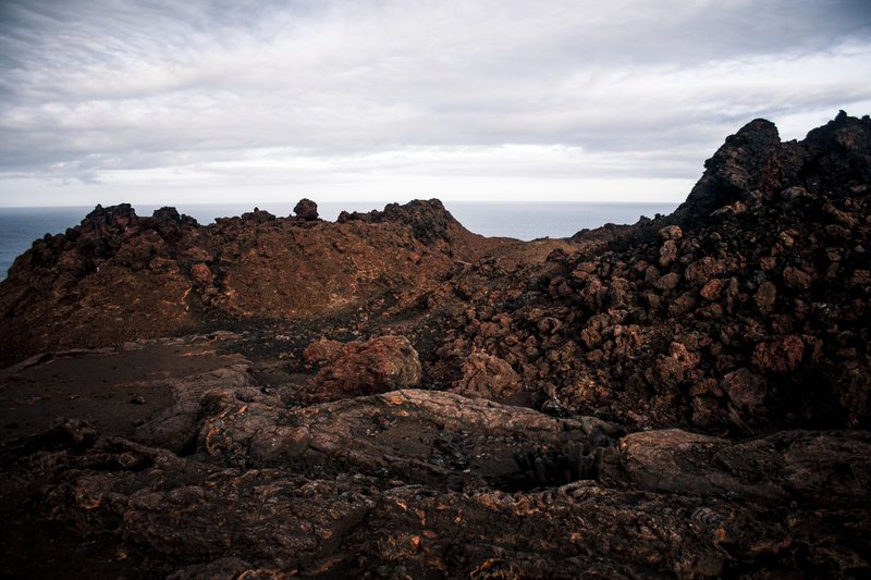 Explore the rugged volcanic terrain of Bartolome Island in the Galapagos, captured in dramatic detail.