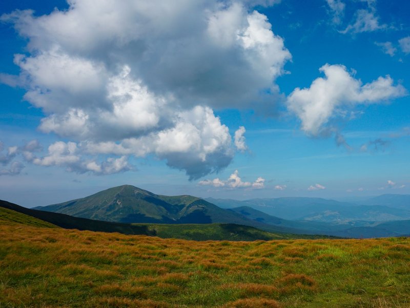 Stunning view of the Carpathians in Ukraine with vibrant greenery and dramatic clouds.